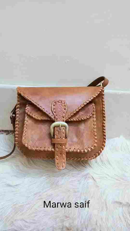Genuine leather bag with a copper belt