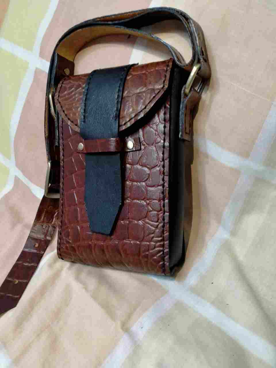 Genuine cowhide leather mobile bag with crocodile print on it and lined from the inside with pockets