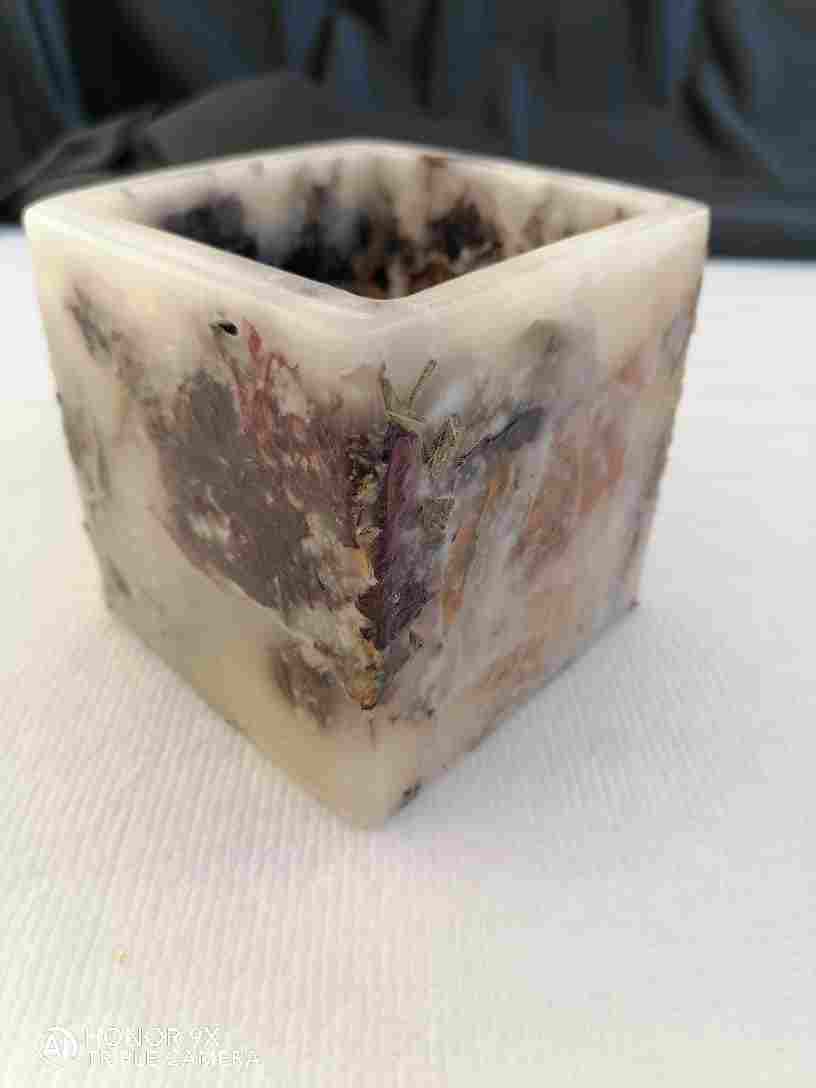 A square candle with a rose inside