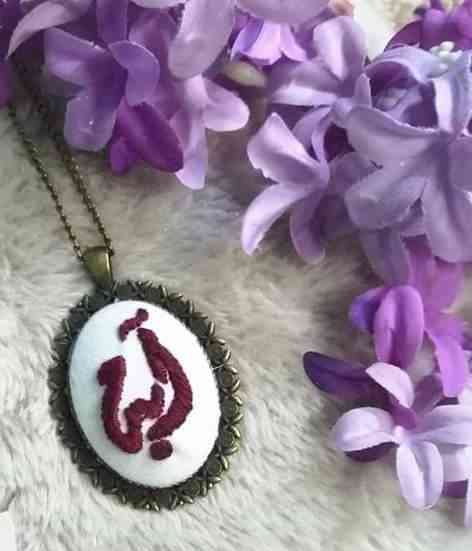 Handmade Maloney thread embroidery necklace on a metal frame