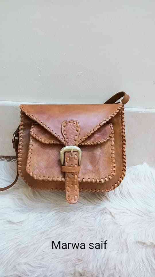 Genuine leather bag with a copper belt