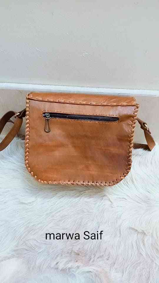 Genuine leather bag with a copper belt