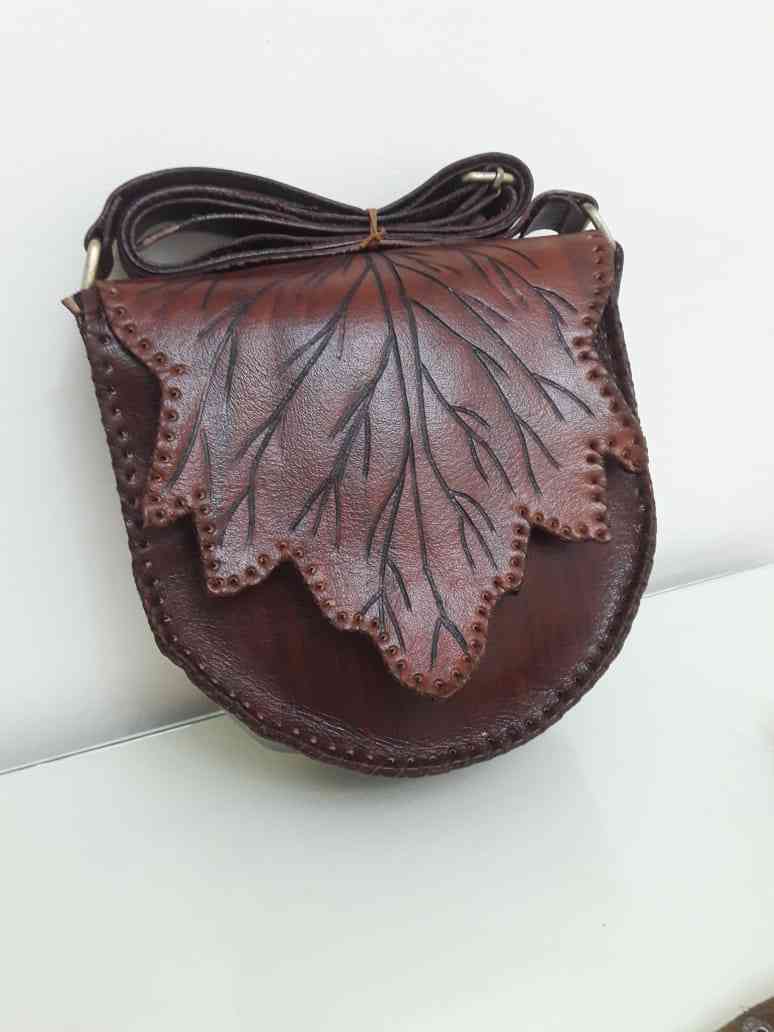 The tree leaf bag is genuine leather, hand burnt, cross