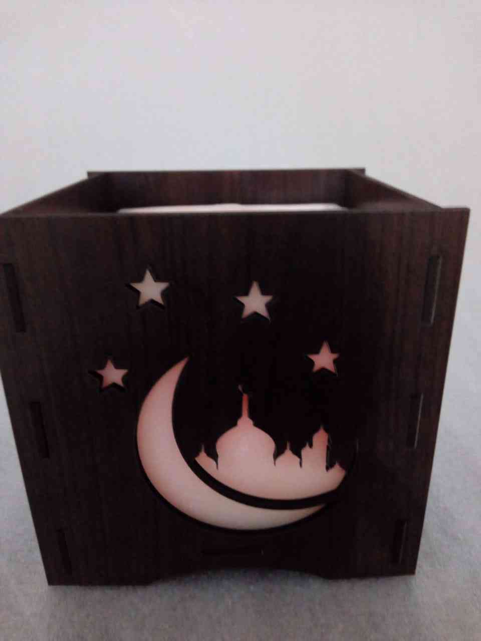 Permanent vacuum wax inside a small candle with the scents of Ramadan Inside a wood box engraved Ramadan shapes