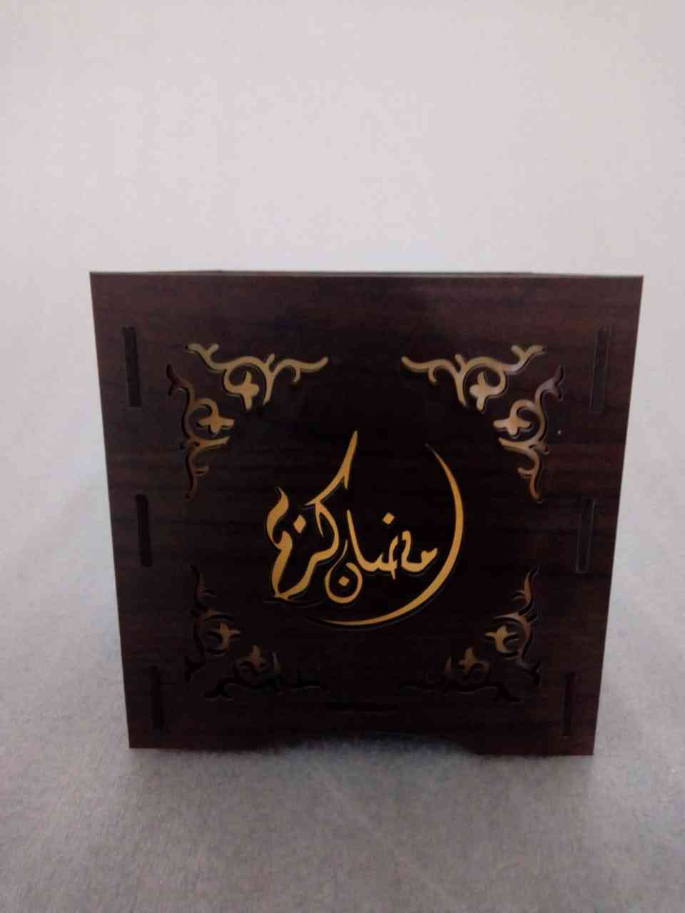 Permanent vacuum wax inside a small candle with the scents of Ramadan Inside a wood box engraved Ramadan shapes