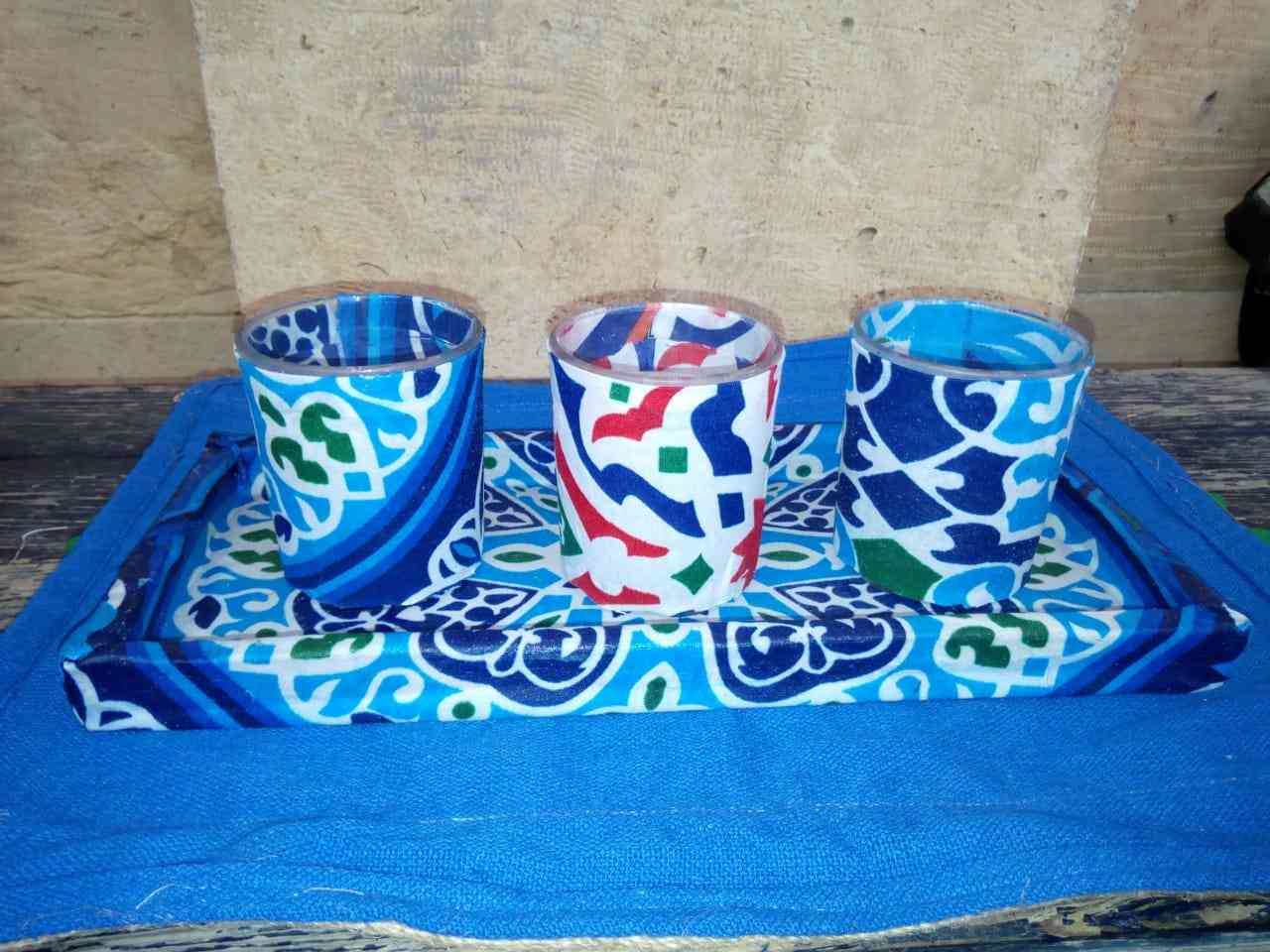 A set of three scented candle cups with the scent of oud with a wooden stand decorated with Khayameya cloth available in all colors