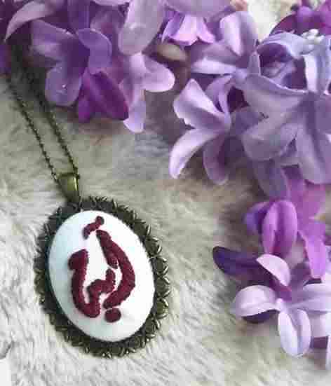 Handmade Maloney thread embroidery necklace on a metal frame