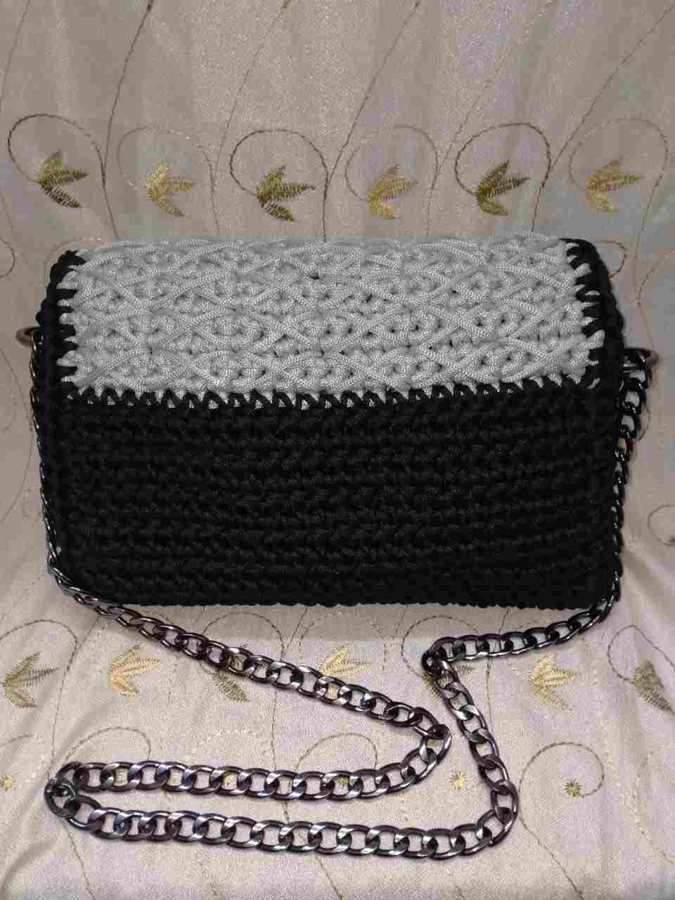 A crochet bag with a metal chain hand