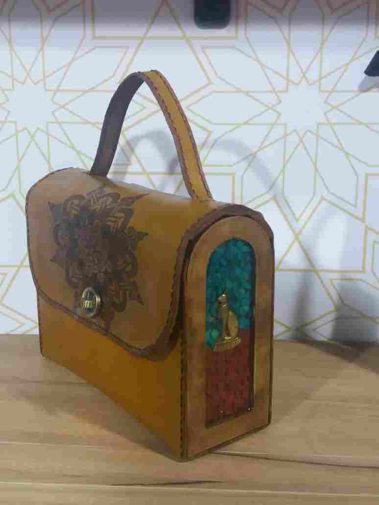 A small cross bag and a small hand and in the middle of Italian Bull-Up leather with sides of wood, stones and resin work